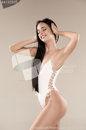 Image of The figure of girl in a swimsuit on studio background