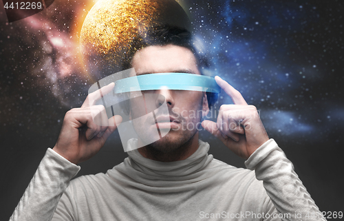 Image of man in 3d glasses over space background
