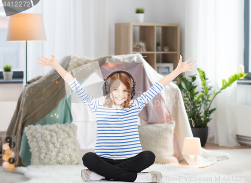 Image of girl with headphones listening to music at home