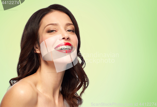 Image of beautiful smiling young woman with red lipstick