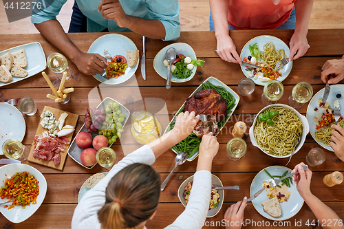 Image of group of people eating chicken for dinner