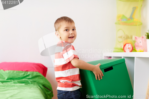 Image of happy little boy with toy box at home