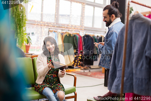 Image of couple choosing footwear at vintage clothing store