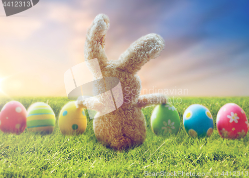 Image of close up of colored easter eggs and toy bunny