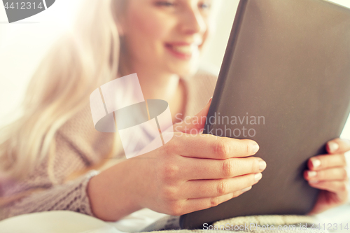 Image of close up of young woman with tablet pc at home