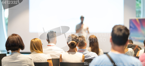 Image of Business speaker giving a talk at business conference event.