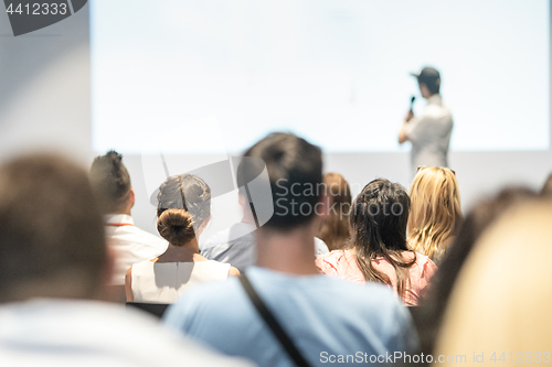 Image of Business speaker giving a talk at business conference event.