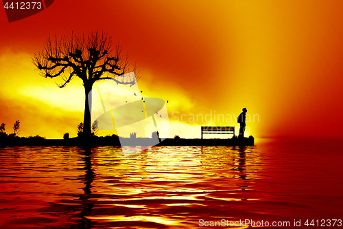 Image of man at the sunset lake