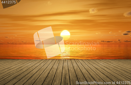 Image of a beautiful golden sunset over the ocean and a wooden jetty