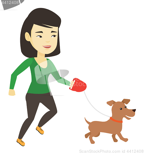 Image of Young woman walking with her dog.