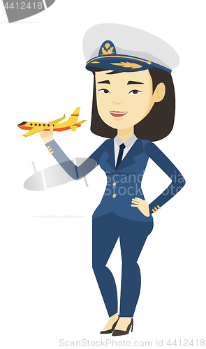 Image of Cheerful airline pilot with model airplane.