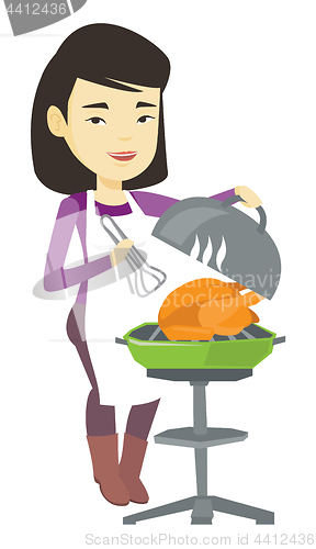 Image of Woman cooking chicken on barbecue grill.