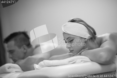 Image of young couple lying on massage table