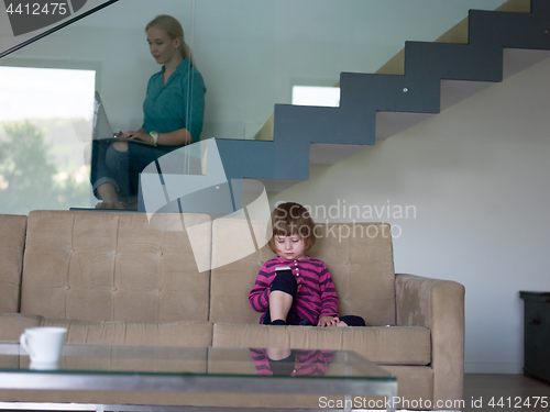 Image of little girl playing games on smartphone