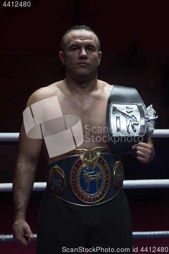 Image of kick boxer with his championship belt