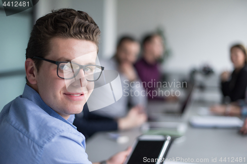 Image of Businessman using tablet in modern office