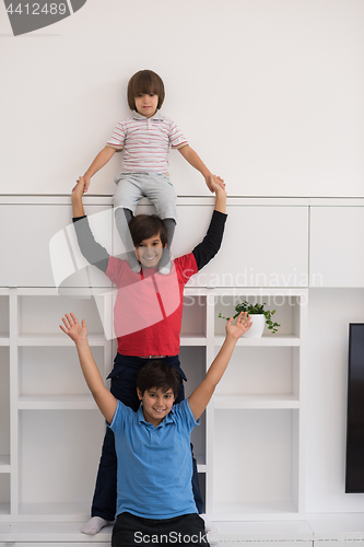 Image of young boys posing line up piggyback