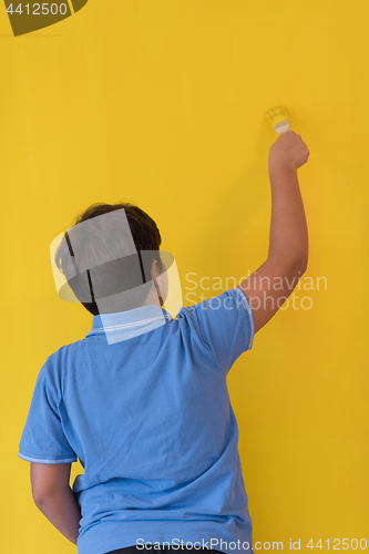 Image of Portrait of a happy young boy painter