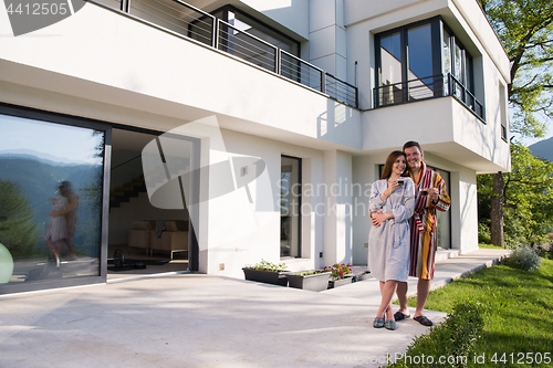 Image of Young beautiful couple in bathrobes