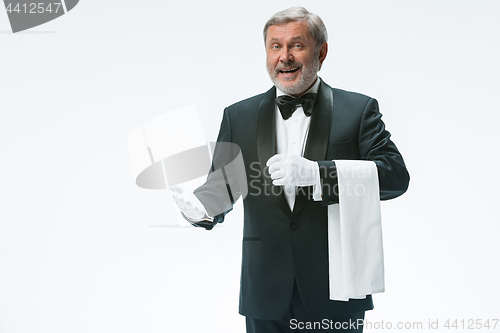 Image of Senior waiter holding white towel