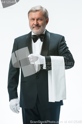 Image of Senior waiter holding white towel