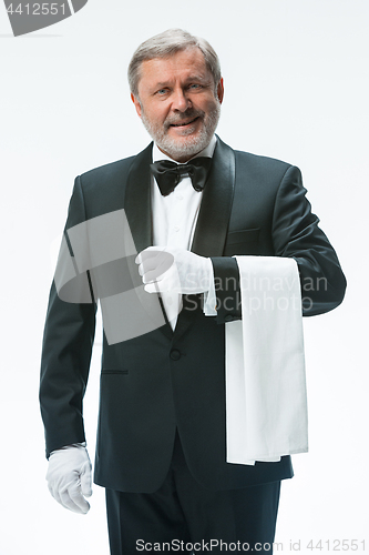 Image of Senior waiter holding white towel