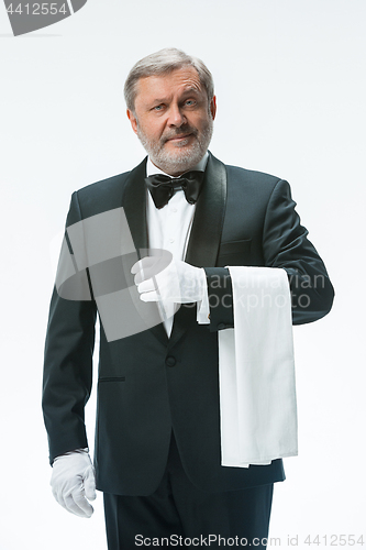 Image of Senior waiter holding white towel