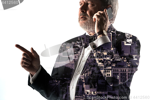 Image of Portrait of bearded businessman with phone. Double exposure city on the background.