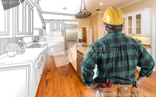 Image of Male Contractor with Hard Hat and Tool Belt Looking At Custom Ki