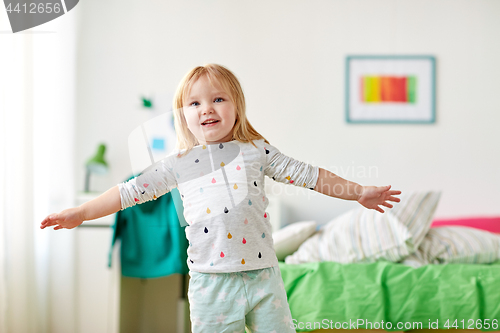Image of happy little girl having fun at home