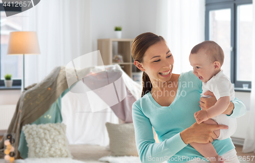 Image of happy young mother with little baby at home