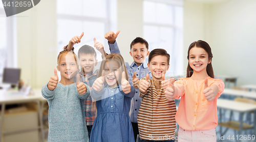 Image of happy students showing thumbs up at school