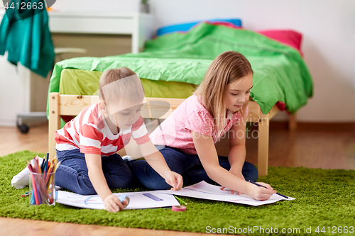 Image of happy kids drawing at home