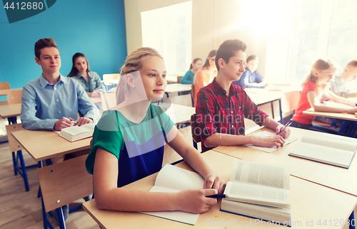 Image of group of students with books at school lesson