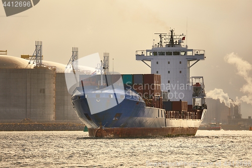 Image of Ship carrying containers through Rotterdam