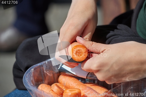 Image of Cutting carrots with a knife