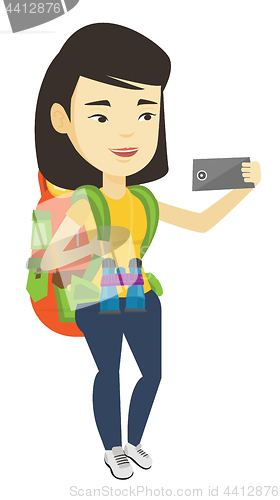 Image of Woman with backpack making selfie.