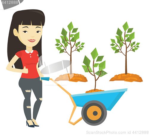 Image of Woman pushing wheelbarrow with plant.