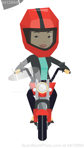 Image of Woman riding motorcycle at night.