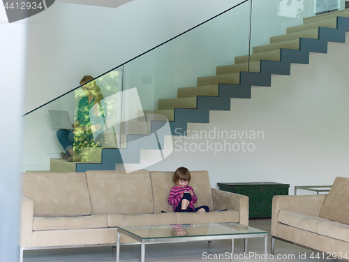 Image of little girl playing games on smartphone