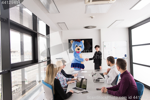 Image of boss dresed as bear having fun with business people in trendy of