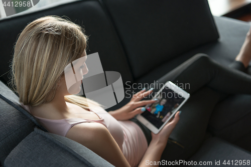 Image of woman using tablet in beautiful apartment