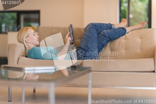 Image of woman on sofa using tablet computer