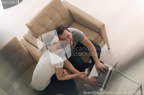 Image of happy young couple buying online