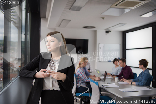 Image of Business Girl Standing In A Modern Building Near The Window With