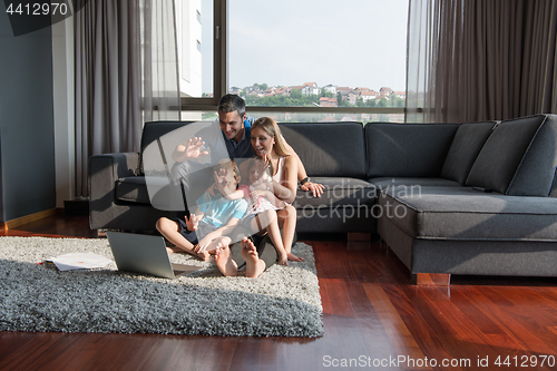 Image of Family Playing Together with laptop computer