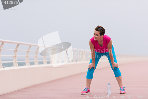 Image of woman stretching and warming up on the promenade