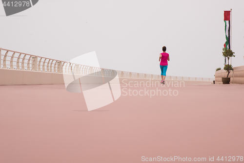 Image of woman busy running on the promenade