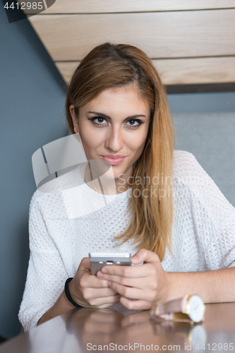 Image of young woman using mobile phone