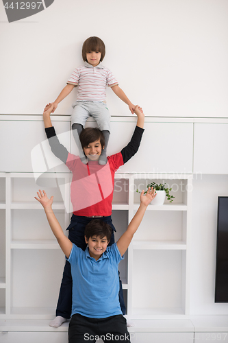 Image of young boys posing line up piggyback